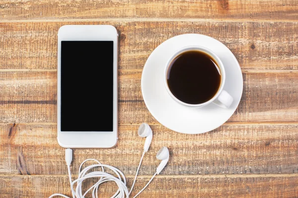 Καφέ και κινητό τηλέφωνο με ακουστικά — Φωτογραφία Αρχείου