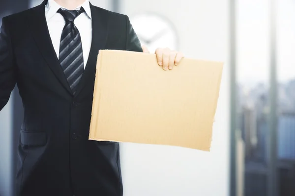 Businessman with blank carton board — Stock Photo, Image
