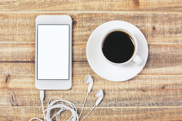 Tabell med kaffe och telefon — Stockfoto