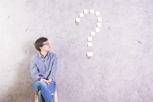 Guy looking at question mark — Stock Photo, Image