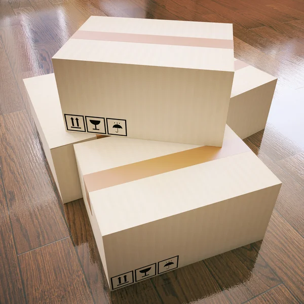 Cardboard boxes on wooden floor — Stock Photo, Image