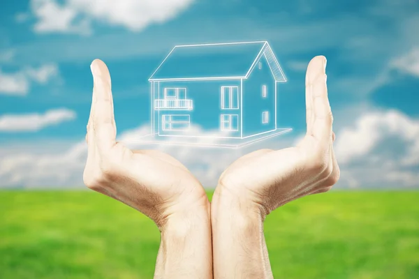 Male hands holding abstract house on beautiful landscape background. Mortgage and real estate concept — Stock Photo, Image