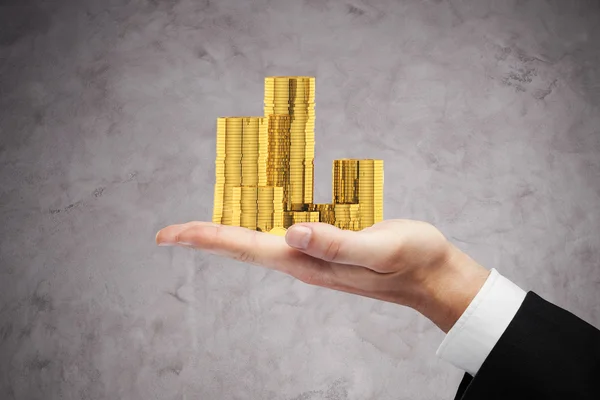 Businessman holding coins — Stock Photo, Image