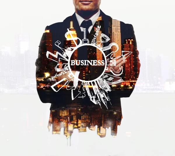 Businessman with business sketch on night city background. Double exposure. Business concept