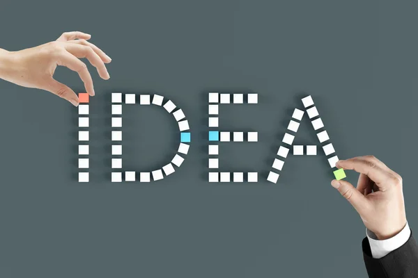 Idea concept hands arranging word — Stock Photo, Image