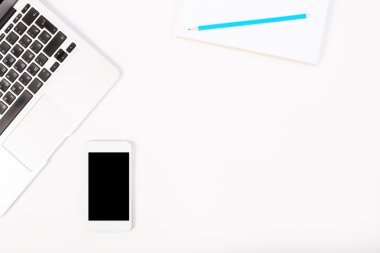 Workplace with keyboard and phone