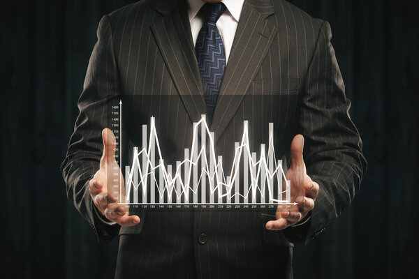 Businessman holding abstract business graph