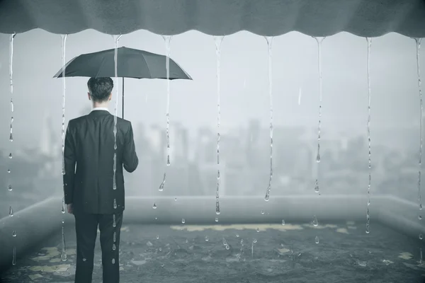 Thoughtful businessman in the rain — Stock Photo, Image
