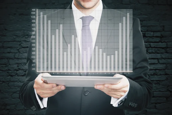 Businessman holding tablet with graph — Stock Photo, Image