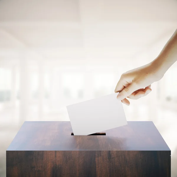Hand casting vote in interior — Stock Photo, Image