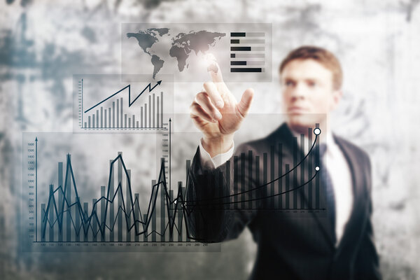 Businessman pointing at business graphs