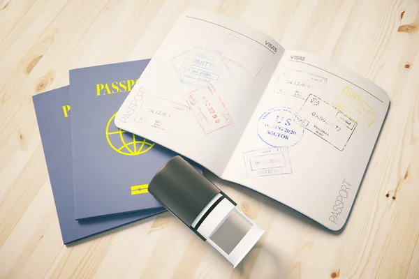 Passport with traveling stamps on light wooden desktop. Topview. Travel concept. — Stock Photo, Image