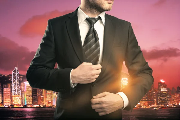 Businessman on red city background — Stock Photo, Image