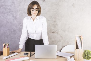 Masaüstünde eğilerek odaklı kadın