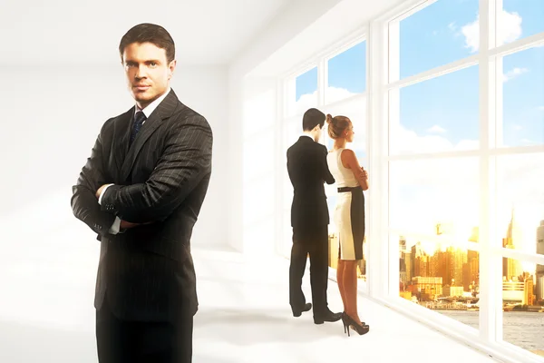 Businesspeople in bright interior with city view and sunlight. Teamwork concept — Stock Photo, Image