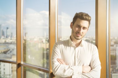 Young guy against window
