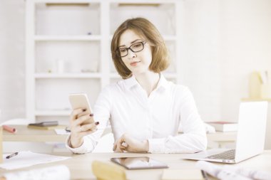 Woman using smartphone and other devices