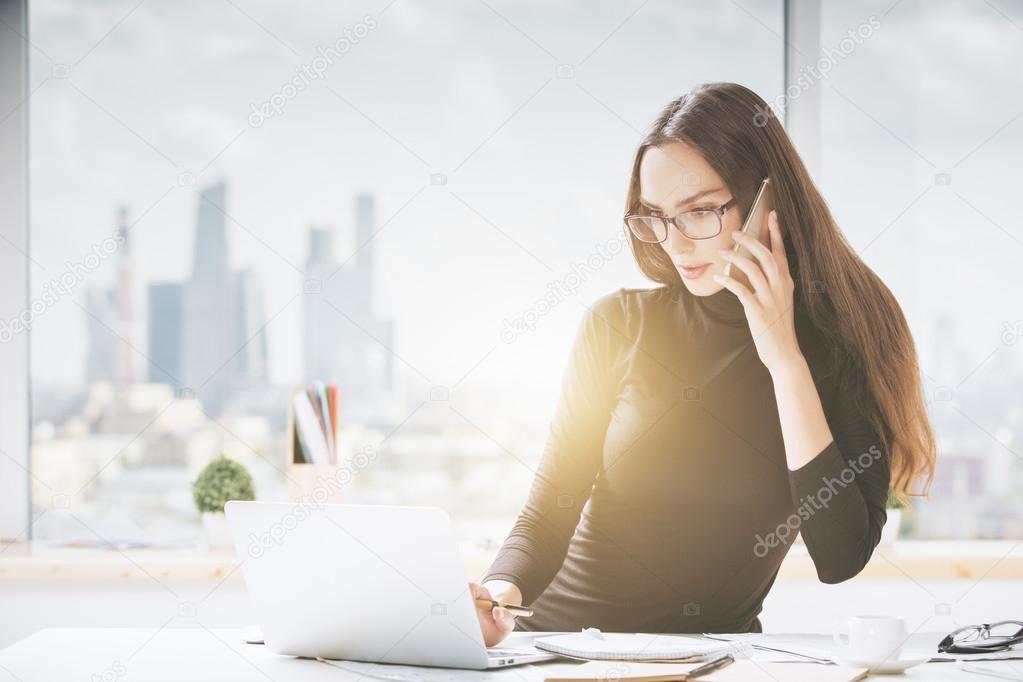 Beautiful young woman in office