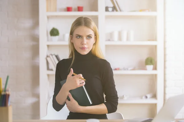 Mujer con pensamiento de bloc de notas en el lugar de trabajo — Foto de Stock