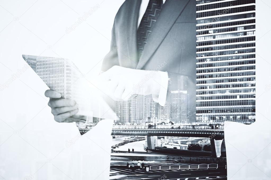 Businessman using pad multiexposure