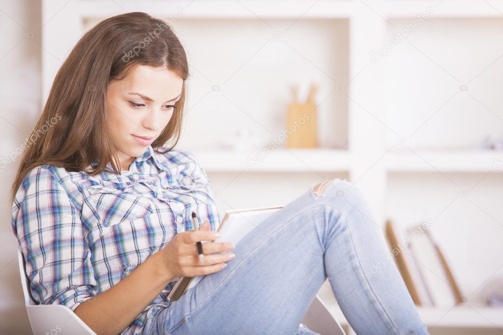 Focused businesswoman writing in notepad