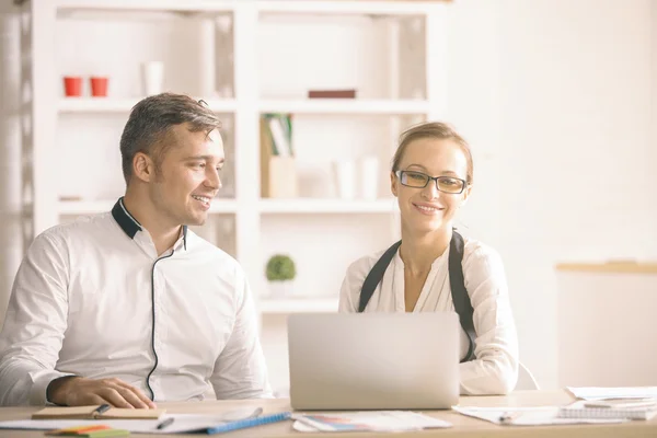 Attractive man and woman in office — Stock Photo, Image