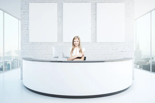 Cheerful woman at reception desk — Stock Photo, Image