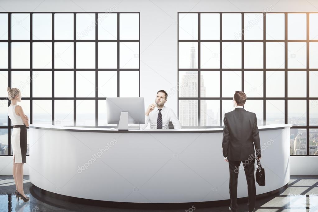 Businesspeople at reception desk 