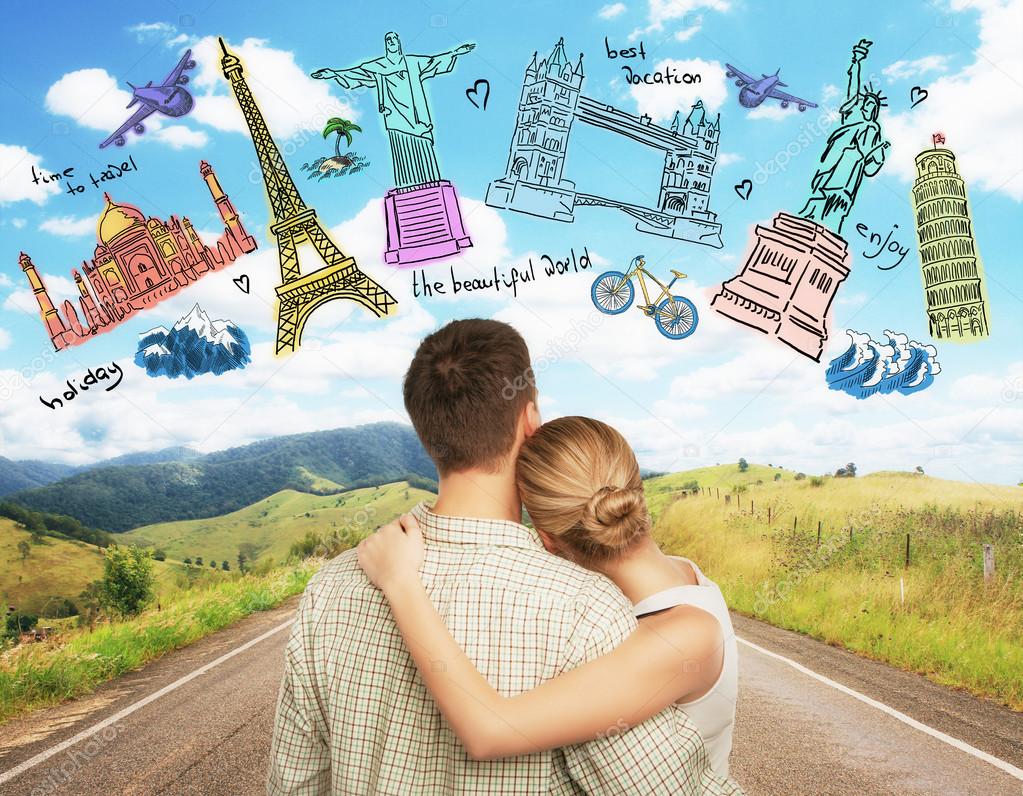 Young caucasian couple looking at creative travel sketch on landscape background. Traveling concept