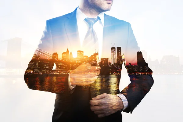 Businessman on city background multiexposure — Stock Photo, Image