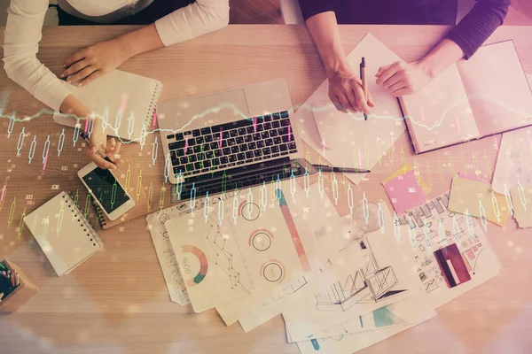 Double exposure of woman hands working on computer and forex graph hologram drawing. Top View. Financial analysis concept.