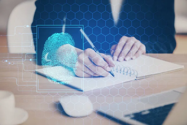 Blue fingerprint hologram over hands taking notes background. Concept of security. Double exposure