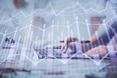 Bilgisayarda ve finansal grafik hologramında yazı yazan kadın ellerine çok maruz kalmış. Borsa analizi kavramı.