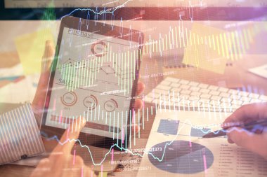 Bir adamın el ele tutuşup, telefon ve finansal çizim kullanırken birden fazla pozlama. Pazar analizi kavramı.