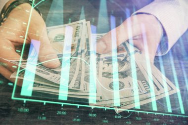 Finansal grafiğe çoklu pozlama hologram, Amerikan dolarları ve insan eli. Analiz kavramı.