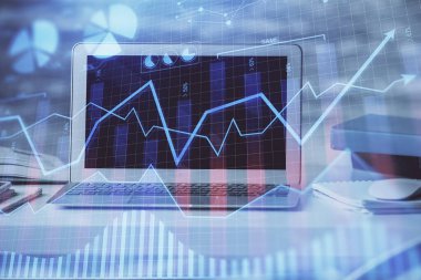 Finansal tablo çizimi ve arka planda bilgisayar olan bir tablo. Çifte maruziyet. Uluslararası pazarlar kavramı.