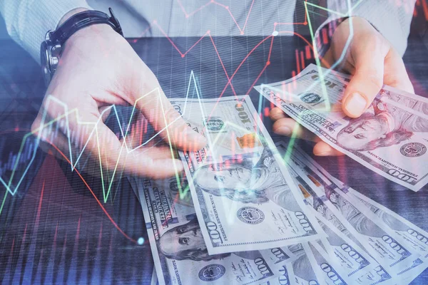 Multi exposición de gráfico financiero dibujo holograma y EE.UU. billetes de dólares y las manos del hombre. Concepto de análisis . —  Fotos de Stock