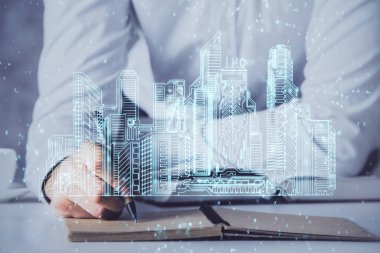 İnsanın el yazısı arkaplanındaki soyut holografik şehir. Çift pozlama.