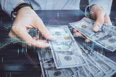 Finansal grafiğe çoklu pozlama hologram, Amerikan dolarları ve insan eli. Analiz kavramı.