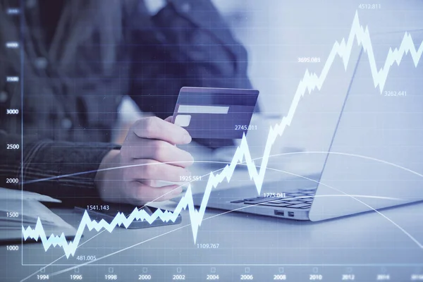 Multi exposure of woman on-line shopping holding a credit card and financial graph drawing. Stock market E-commerce concept.