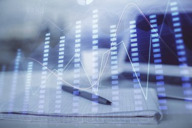 Finansal grafik çizimleri ve açık defter arkaplanı olan bir masa. Önx pazarı kavramı