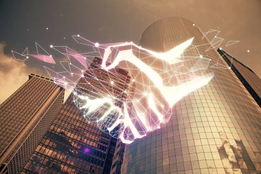 Şehir manzarası arka planında el sıkışma hologramına çifte maruz kalma. Ortaklık kavramı.