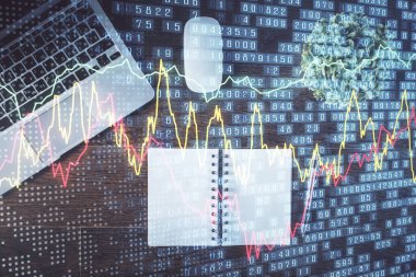 Borsa grafiği ve masa arkasındaki en üst görünüm bilgisayarı. Çifte maruziyet. Finansal eğitim kavramı.