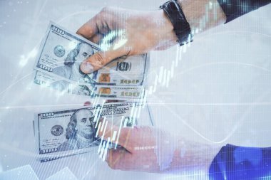 Finansal grafiğe çoklu pozlama hologram, Amerikan dolarları ve insan eli. Analiz kavramı.
