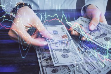 Finansal grafiğe çoklu pozlama hologram, Amerikan dolarları ve insan eli. Analiz kavramı.