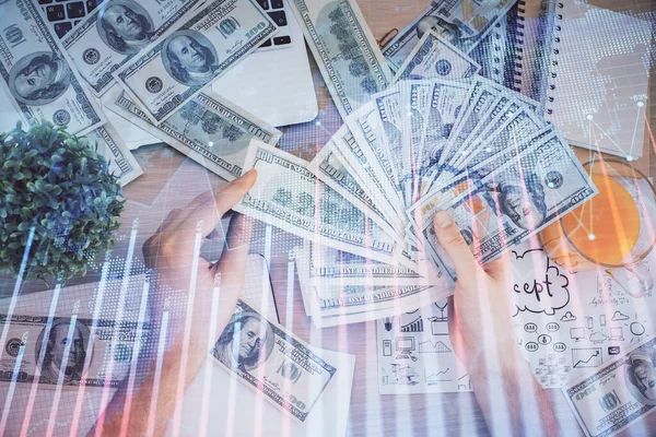 Multi eksponering af finansielle graf tegning hologram og USA dollars regninger og mand hænder. Analysekoncept. - Stock-foto