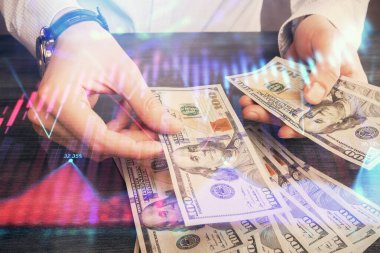 Finansal grafiğe çoklu pozlama hologram, Amerikan dolarları ve insan eli. Analiz kavramı.