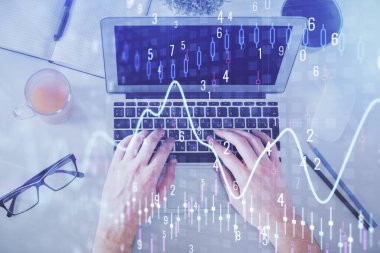 Dizüstü bilgisayar klavyesini ve ön x çizim hologramını yazarken çift pozlama. Üst Manzara. Finans piyasası kavramı.