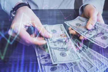 Finansal grafiğe çoklu pozlama hologram, Amerikan dolarları ve insan eli. Analiz kavramı.