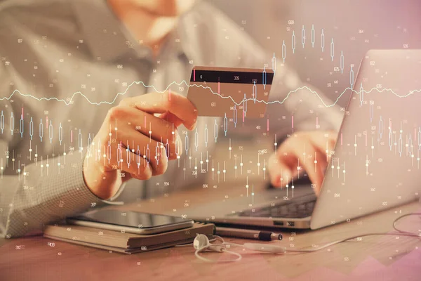 Double exposure of man hands holding a credit card and Forex graph drawing. Stock trading and digital fintech in Internet E-commerce concept. — Stock Photo, Image